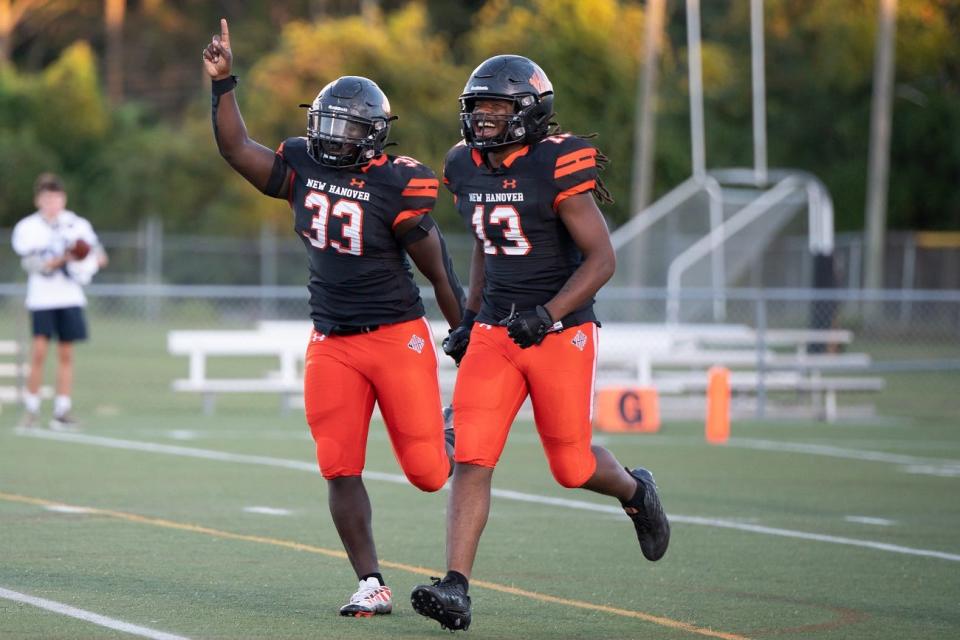 Jarron Frost (33) and Cornelius Allen celebrate after a New Hanover blocked punt for a touchdown as New Hanover hosts South Brunswick Friday night.  September 23, 2022.  [KEN OOTS/FOR STARNEWS]