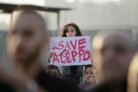 A Syrian girl holds a placard during a rally in solidarity with Aleppo, in the Lebanese city of Tripoli, on May 1, 2016