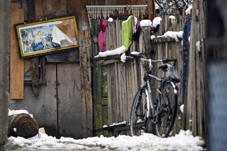 A damaged religious icon hangs in the back yard of a house in Leresti, Romania, Saturday, Jan. 9, 2021. Valeriu Nicolae and his team visited villages to deliver aid. The rights activist has earned praise for his tireless campaign to change for the better the lives of the Balkan country’s poorest and underprivileged residents, particularly the children. (AP Photo/Andreea Alexandru)