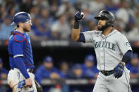 Seattle Mariners designated hitter Carlos Santana, right, celebrates after his three-run home run against the Toronto Blue Jays during the sixth inning of Game 2 of a baseball AL wild-card playoff series Saturday, Oct. 8, 2022, in Toronto. (Frank Gunn/The Canadian Press via AP)