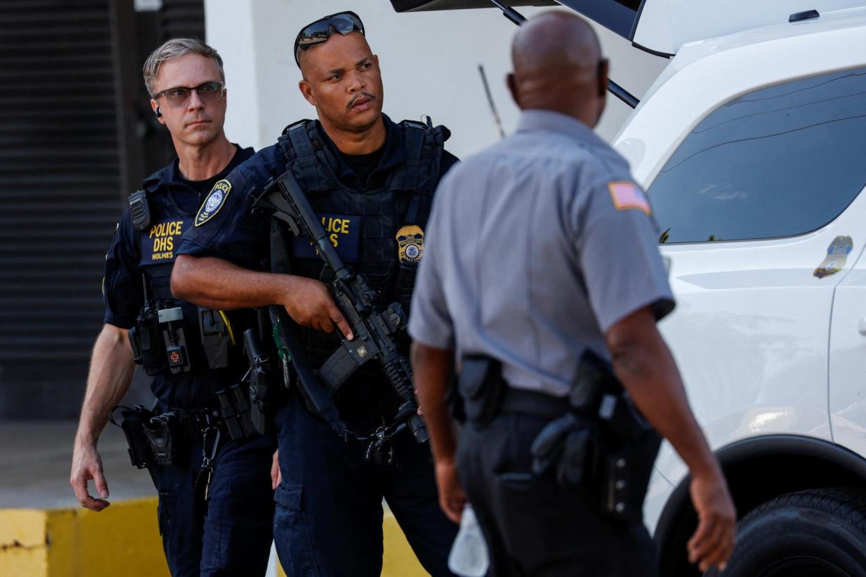 <span>Police officers stand outside a courthouse ahead of a possible planned court appearance for Ryan Wesley Routh in West Palm Beach, Florida, on Monday.</span><span>Photograph: Marco Bello/Reuters</span>