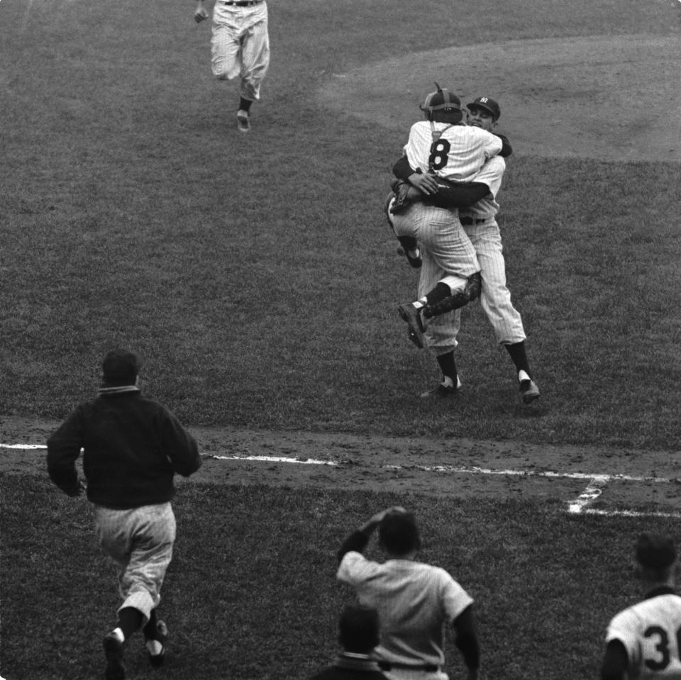 NEW YORK - OCTOBER 8:  Pitcher Don Larsen (r), of the New York Yankees, wraps his arms around catcher Yogi Berra #8 after the final pitch of Game 5 of the 1956 World Series against the Brooklyn Dodgers at Yankee Stadium in New York.  Larsen pitched the first perfect game in World Series history as the Yankees defeated Sal Maglie and the Dodgers, 2-0. (Photo by: Diamond Images/Getty Images)