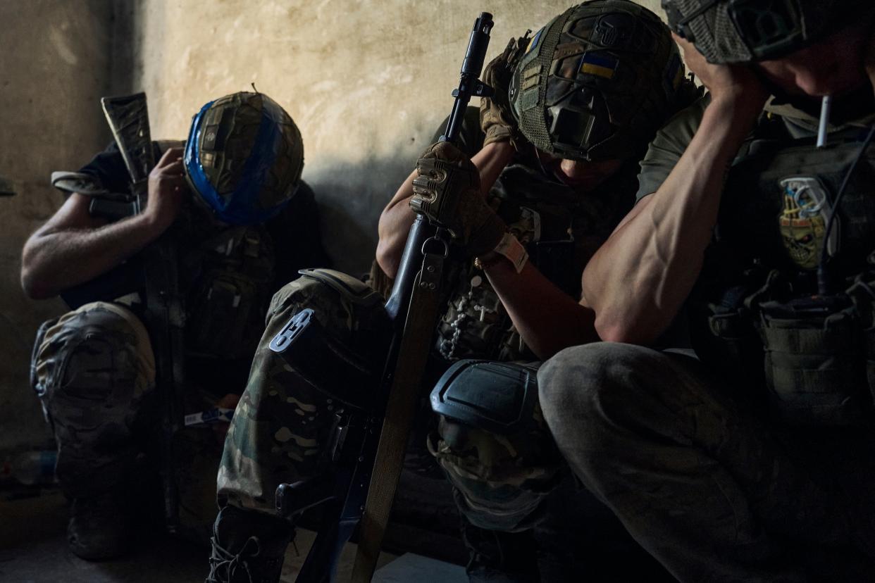 krainian soldiers cover their ears to protect from the Russian tank shelling in a shelter on the frontline in the Zaporizhzhia region (AP)