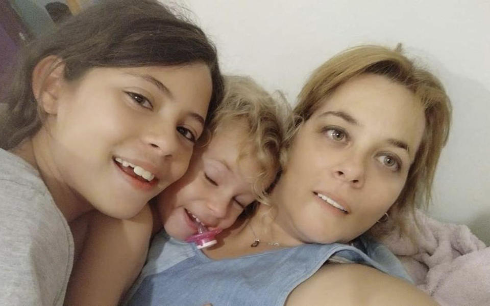 Dafna Elyakim, 15 and Ella Elyakim, 8, with their mother, Maayan Ziv. Dafna and Ella have been taken hostage. (Maayan Ziv via AP)