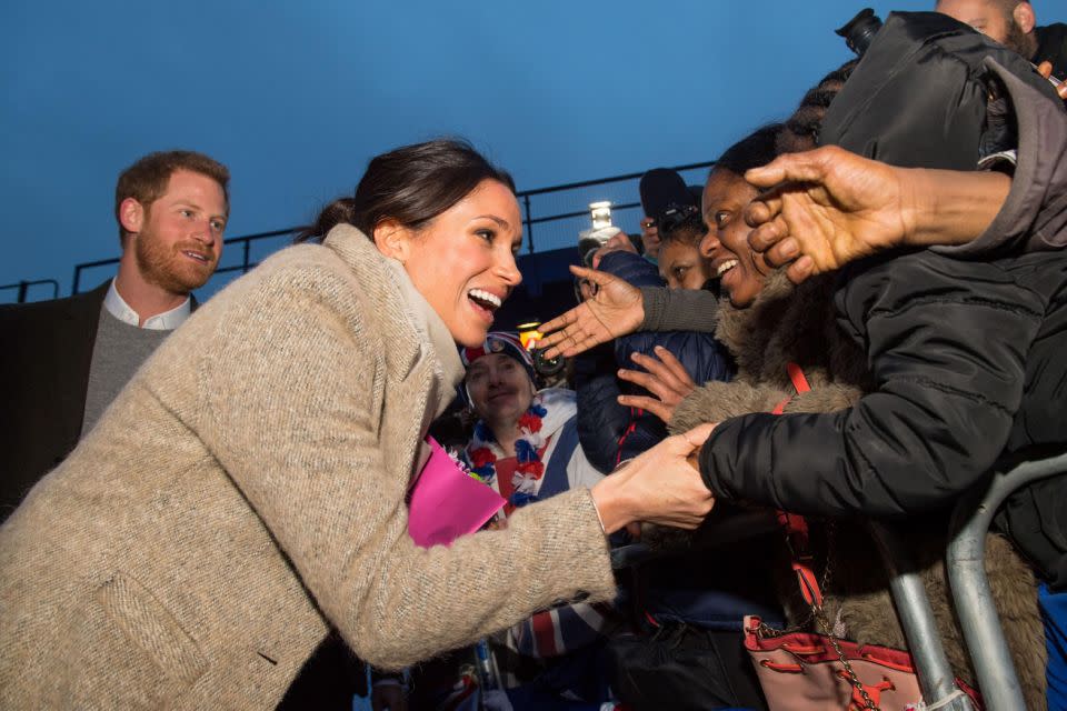She held the hand of one woman who started crying. Photo: Getty