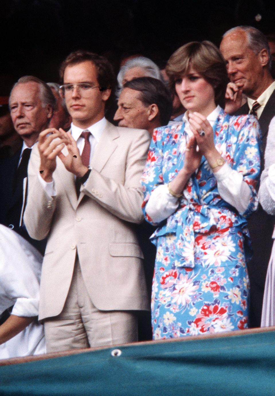 Prince Albert of Monaco joins Lady Diana Spencer in the ovation for John McEnroe after he had beaten Bjorn Borg in the Wimbledon finals.