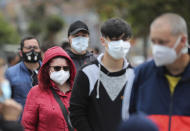 Residents line up to take a nasal swab sample for COVID-19 tests, provided for free by the municipal government in Bogota, Colombia, Friday, Oct. 16, 2020. (AP Photo/Fernando Vergara)