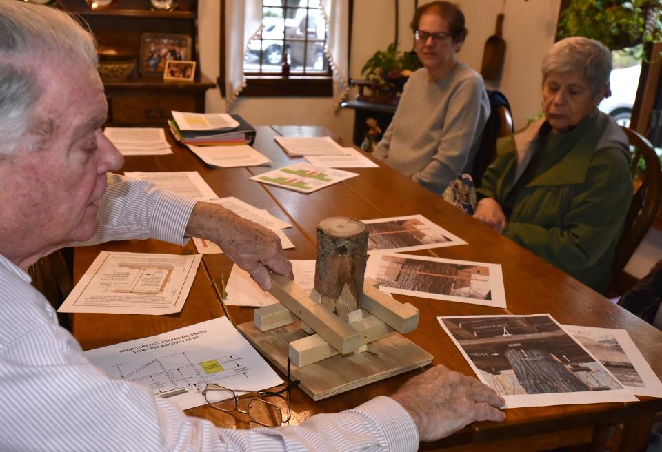 Carlo DiPersio walks his Sandwich neighbors, Nancy Andrews and Lorraine Miller, right, through some of his documentation of the Heritage Museum's adventure park, including a model he built showing how the platforms are attached to the trees.