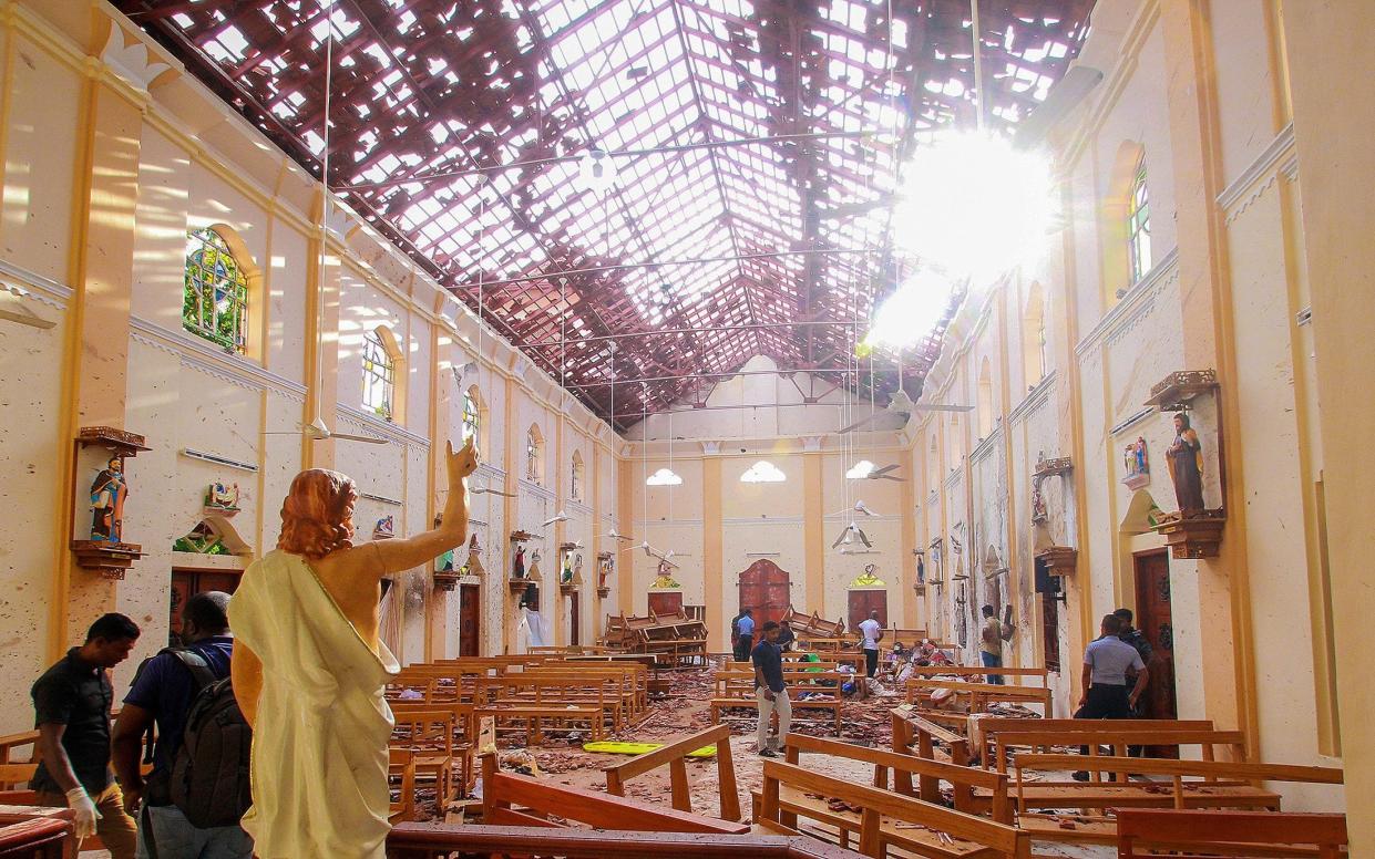  Crime scene officials inspect the site of a bomb blast inside St Sebastian's Church in Negombo - REUTERS