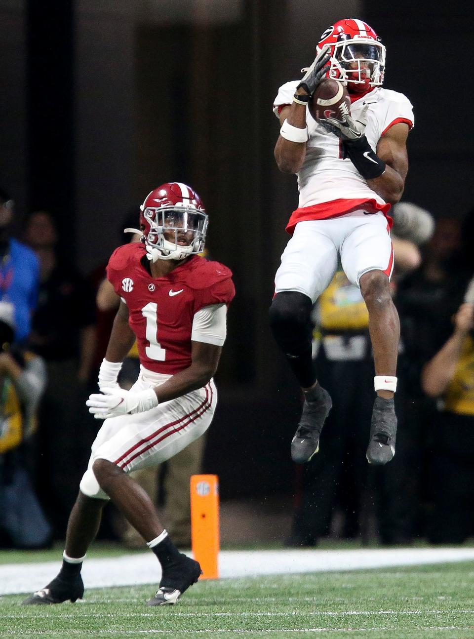 Dec 4, 2021; Atlanta, GA, USA; Georgia Bulldogs wide receiver George Pickens (1) catches a long pass against Alabama defensive back Kool-Aid McKinstry (1) in the SEC championship game at Mercedes-Benz Stadium. Mandatory Credit: Gary Cosby Jr.-USA TODAY Sports