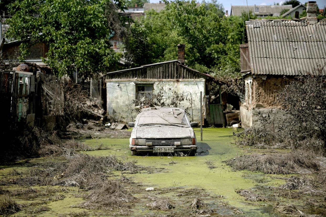 An abandoned car in Kherson in an area flooded by rising water following the collapse of the Kakhovka hydroelectric power plant dam (AFP via Getty Images)