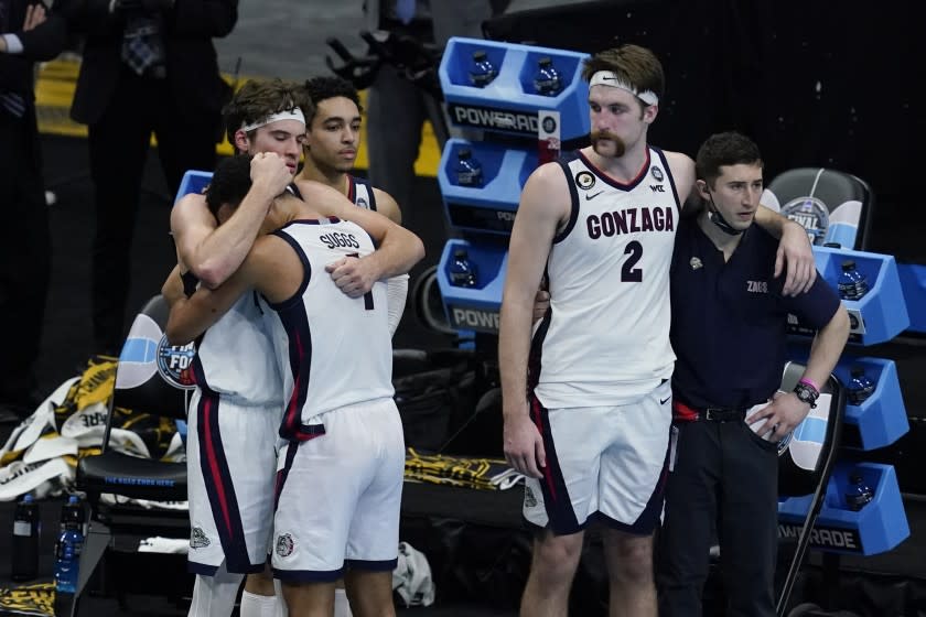 Gonzaga forward Corey Kispert (24) hugs Jalen Suggs (1) as Gonzaga forward Drew Timme (2) looks on at the end of the championship game against Baylor in the men's Final Four NCAA college basketball tournament, Monday, April 5, 2021, at Lucas Oil Stadium in Indianapolis. Baylor won 86-70. (AP Photo/Darron Cummings)