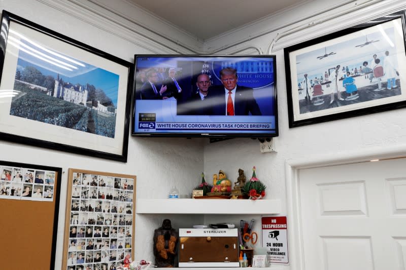 U.S. President Donald Trump is seen on a television at Chateau Barber Shop in Napa