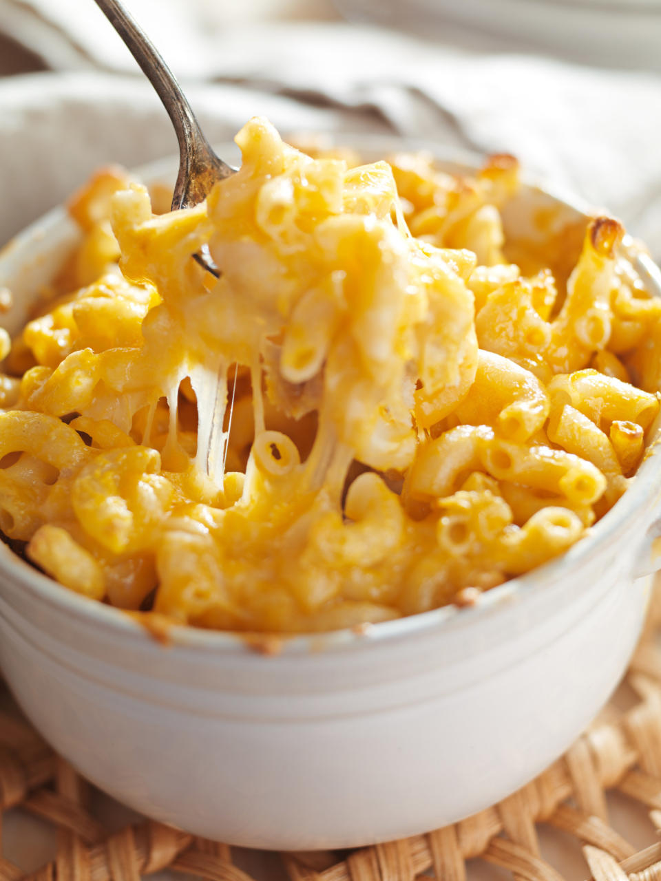 A spoon in a bowl of mac 'n' cheese