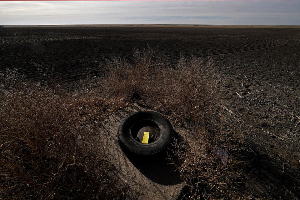 A yellow tag noting water levels is left on an unused irrigation well near Marienthal, Kan.