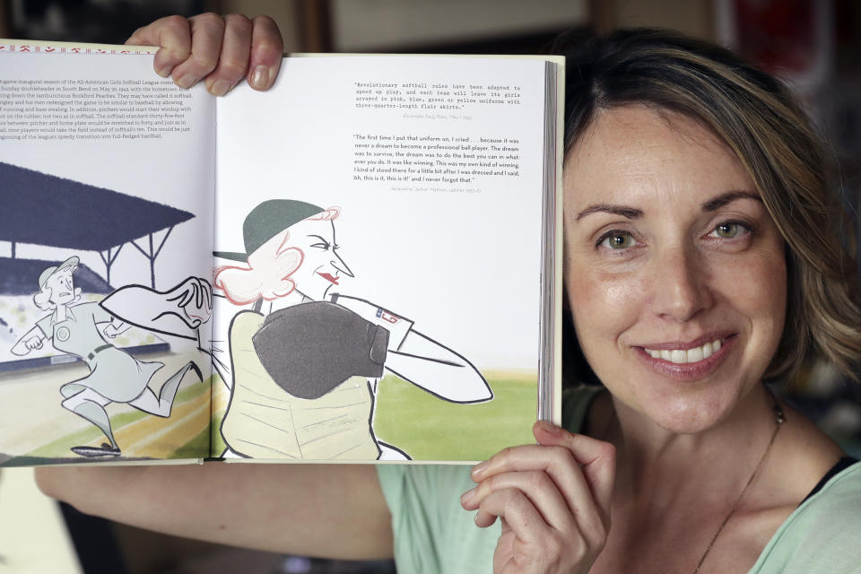 This April 30, 2020, photo, shows Anika Orrock with one of her illustrations from her book "The Incredible Women of the All-American Girls Professional Baseball League" in her home in Nashville, Tenn. (AP Photo/Mark Humphrey)