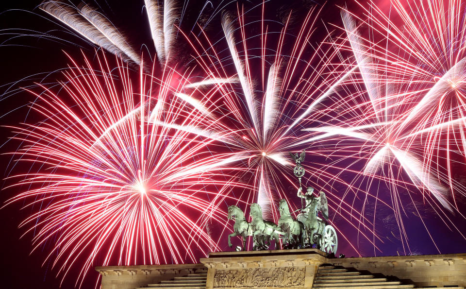 Fireworks explode over the Brandenburg Gate during New Year's festivities on January 1, 2018 in Berlin, Germany. (Photo: Adam Berry via Getty Images)