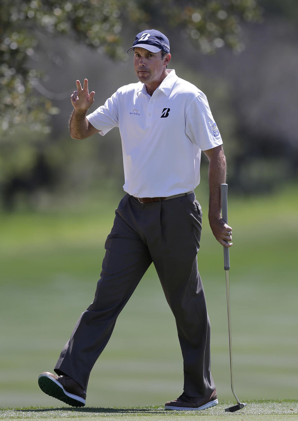 Matt Kuchar waves to fans after making a birdie putt on the eighth hole during the final round of the Texas Open golf tournament on Sunday, March 30, 2014, in San Antonio. (AP Photo/Eric Gay)