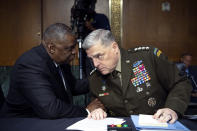 Secretary of Defense Lloyd Austin, left, and Chairman of the Joint Chiefs Chairman Gen. Mark Milley talk before a Senate Appropriations Committee hearing to examine proposed budget estimates and justification for fiscal year 2022 for the Department of Defense in Washington on Thursday, June 17, 2021. (Caroline Brehman/Pool via AP)