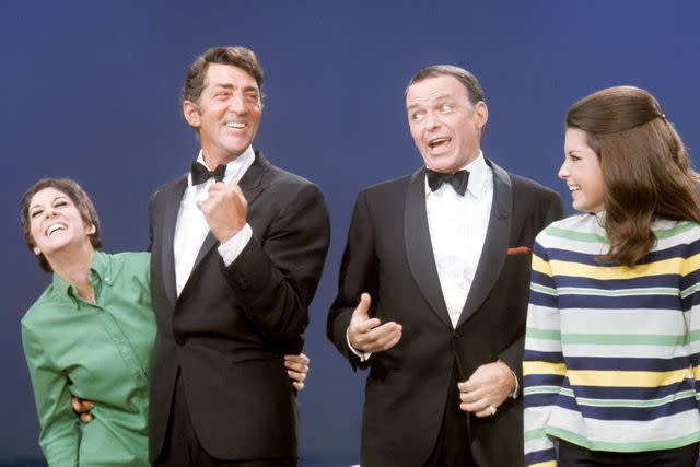 <p>Martin Mills/Getty </p> Dean Martin and daughter Deana share the stage with Frank Sinatra and his daughter Tina circa 1960's.
