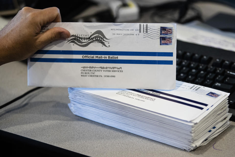 FILE - In this May 28, 2020, file photo, mail-in primary election ballots are processed at the Chester County Voter Services office in West Chester, Pa. Gov. Tom Wolf's top election official said Friday, Aug. 14, that the administration had to take action after receiving a blunt warning from the U.S. Postal Service that it may be unable to deliver some mail-in ballots in the November presidential election by the deadline in state law. That warning precipitated Thursday night's filing in the state Supreme Court asking for an order to extend the deadline for mail-in ballots to be received in the Nov. 3 election when Pennsylvania will be a premier presidential battleground. (AP Photo/Matt Rourke, File)