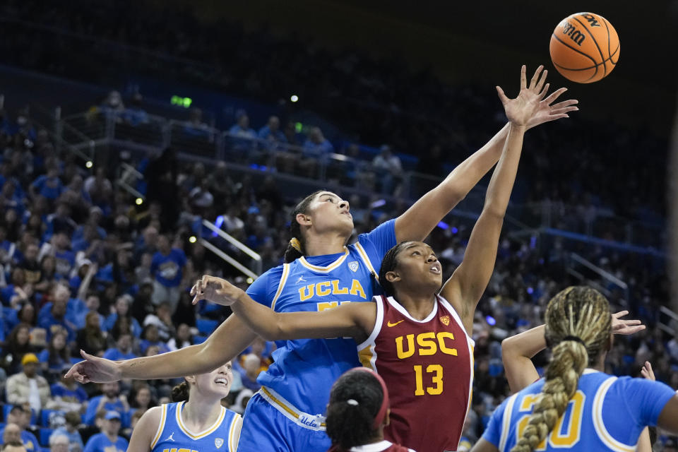 UCLA center Lauren Betts, front left, reaches for a rebound over Southern California center Rayah Marshall (13) during the second half of an NCAA college basketball game Saturday, Dec. 30, 2023, in Los Angeles. (AP Photo/Marcio Jose Sanchez)