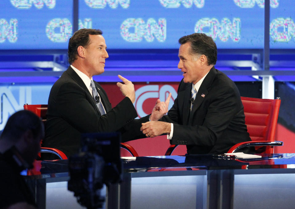 Republican presidential candidates, former Pennsylvania Sen. Rick Santorum, left, and former Massachusetts Gov. Mitt Romney talk following a Republican presidential debate Wednesday, Feb. 22, 2012, in Mesa, Ariz. (AP Photo/The Arizona Republic, Nick Oza) MARICOPA COUNTY OUT; MAGS OUT; NO SALES