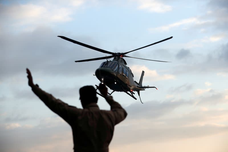 A helicopter carryying Cambodia's Prime Minister Hun Sen arrives at the port as MS Westerdam, a cruise ship that spent two weeks at sea after being turned away by five countries over fears that someone aboard might have the coronavirus, docks in Sihanoukvi