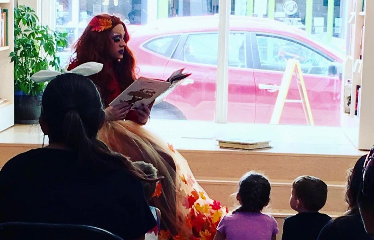 Performer Autumn Equinox reads to an audience during one of Skylark Bookshop's previous Drag Story Time events.