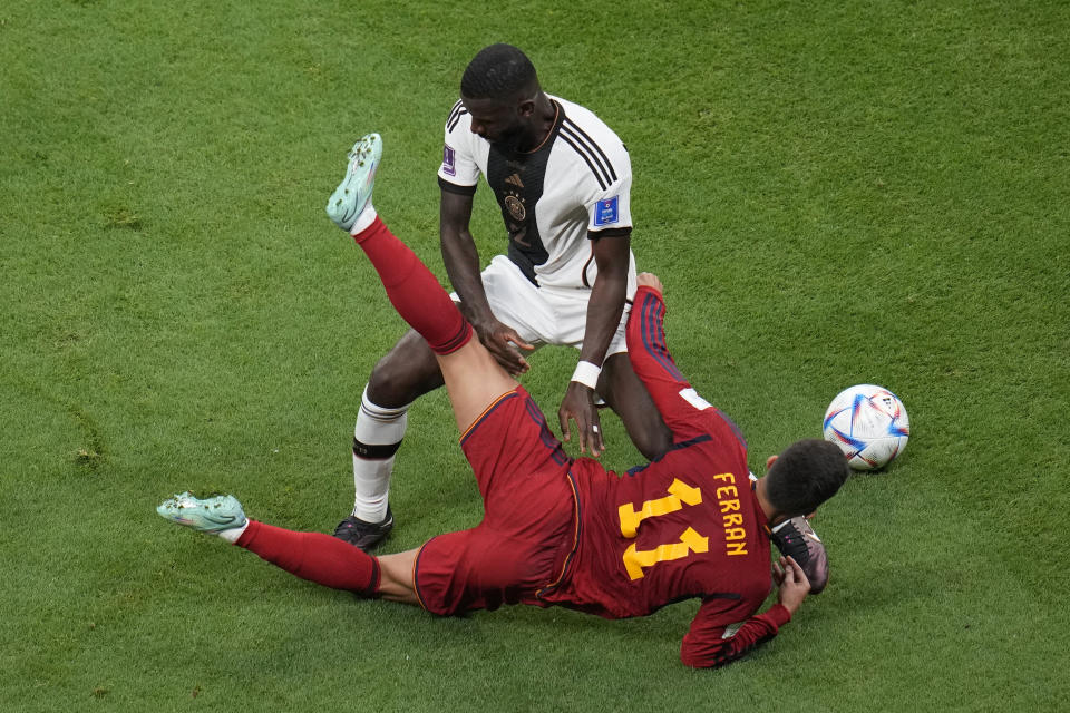 Germany's Antonio Ruediger, atop, challenges for the ball with Spain's Ferran Torres during the World Cup group E soccer match between Spain and Germany, at the Al Bayt Stadium in Al Khor, Qatar, Sunday, Nov. 27, 2022. (AP Photo/Ricardo Mazalan)