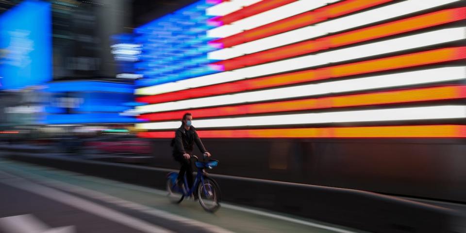 A bicyclist rides through Times Square in New York City on March 25, 2021.