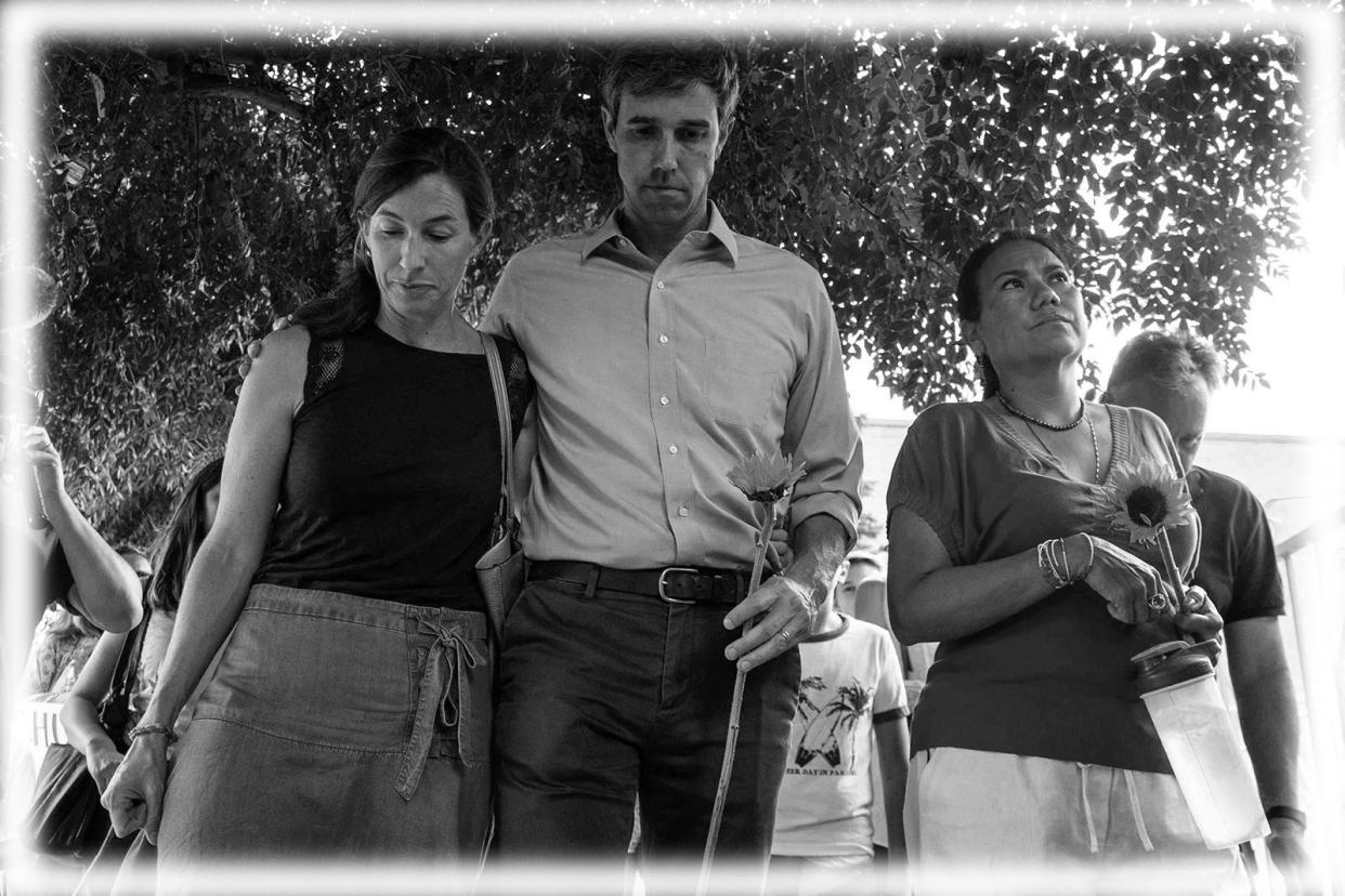 Beto O'Rourke walks next to his wife Amy Hoover Sanders and US Rep. Veronica Escobar during a silent march holding sunflowers in honor to the victims of a mass shooting occurred in Walmart on Satuday morning in El Paso on Sunday, August 4, 2019. (Photo: TNS via ZUMA Wire; digitally enhanced by Yahoo News)