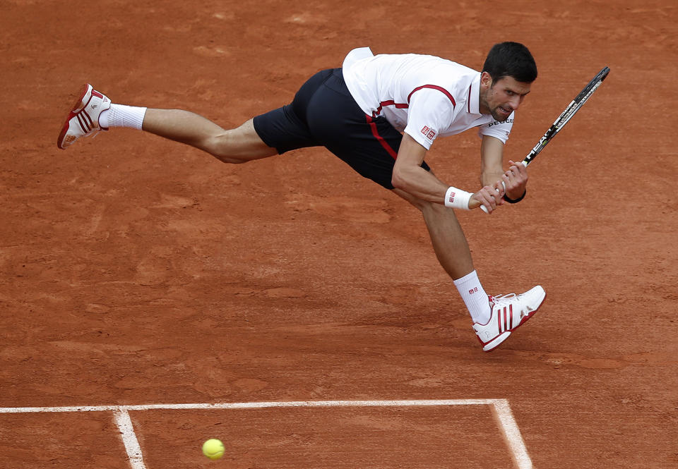 <p>Serbia’s Novak Djokovic returns the ball to Belgium's Steve Darcis during their second round match of the French Open tennis tournament at the Roland Garros stadium, May 26, 2016 in Paris. (Michel Euler/AP) </p>