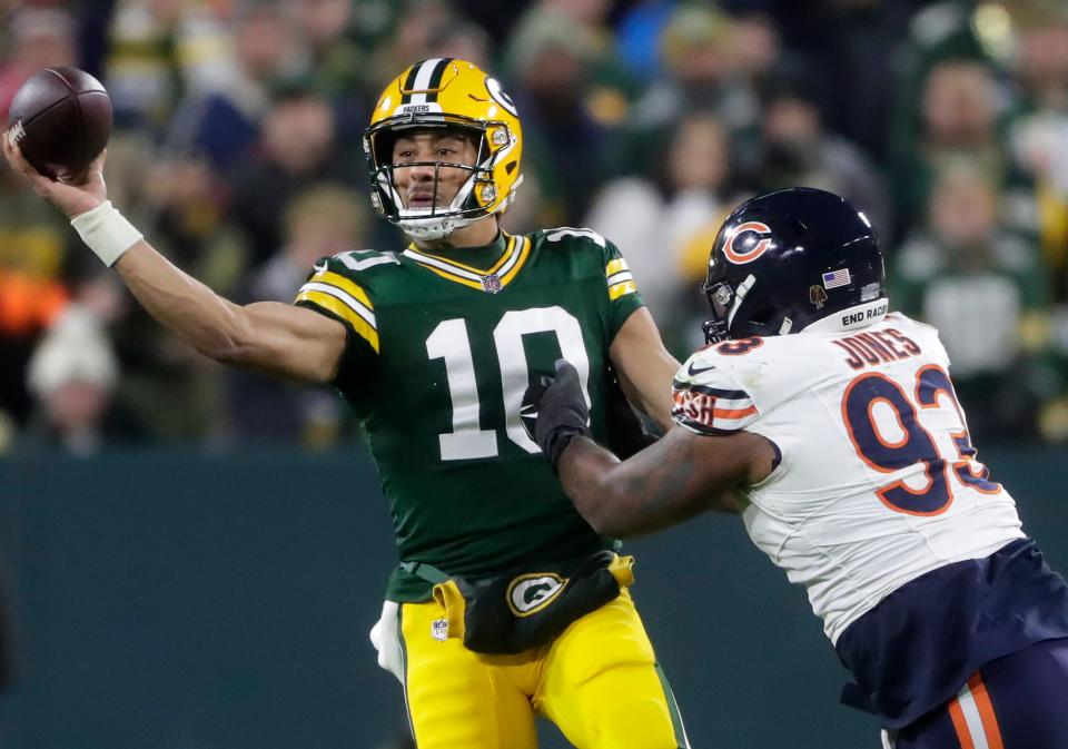 Jan 7, 2024; Green Bay, Wisconsin, USA; Green Bay Packers quarterback Jordan Love (10) throws under pressure from Chicago Bears defensive tackle Justin Jones (93) during their football game at Lambeau Field. Mandatory Credit: Wm. Glasheen-USA TODAY Sports