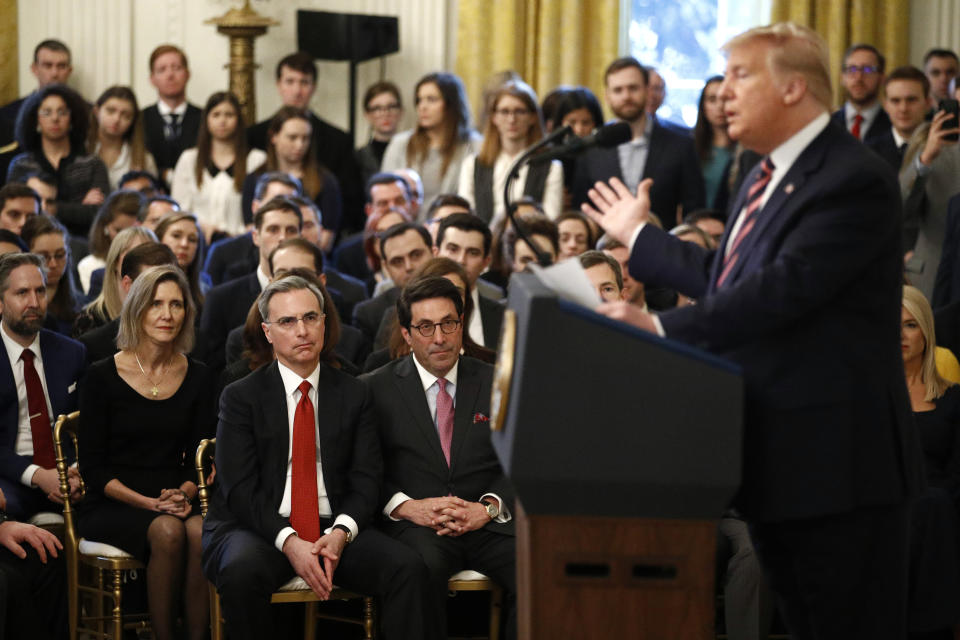 White House counsel Pat Cipollone, bottom left in red tie, and Jay Sekulow, President Donald Trump's personal lawyer, listen as Trump speaks in the East Room of the White House in Washington, Thursday, Feb. 6, 2020. (AP Photo/Patrick Semansky)