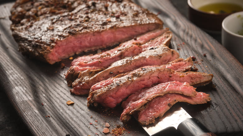 sliced flank steak on board