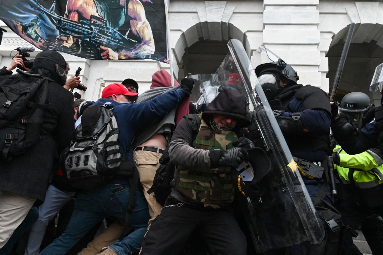 Riot police push back a crowd of supporters of US President Donald Trump after they stormed the Capitol building on January 6, 2021 in Washington, DC. (Roberto Schmidt/AFP via Getty Images)