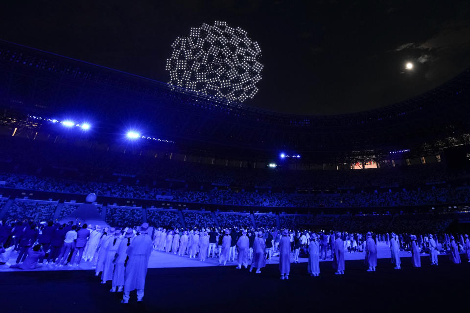 FILE - Drones perform a globe above the roof of the stadium during the opening ceremony in the Olympic Stadium at the 2020 Summer Olympics, Friday, July 23, 2021, in Tokyo, Japan. Creative director Marco Balich, reveals to The Associated Press that he has been working for a year on a 30-minute show that will run ahead of the Soccer World Cup 2022 opening game between Qatar and Ecuador. He says local organizers "wanted to create a real show, which FIFA is not accustomed to.” (AP Photo/Natacha Pisarenko, File)