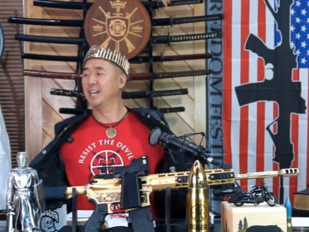 <p>Hyung Jin “Sean” Moon, the leader of Sanctuary Church and Rod of Iron Ministries, delivers his “King’s Report” sermon from behind  a golden AR-15</p> (Twitch screengrab)