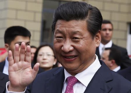 China's President Xi Jinping waves during a visit to a housing development in Caracas July 21, 2014. REUTERS/Carlos Garcia Rawlins