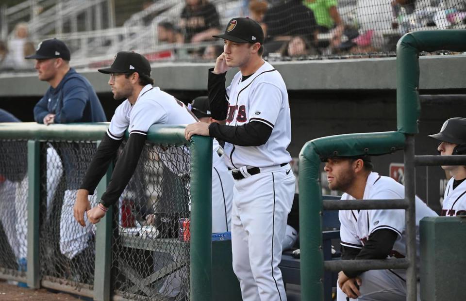 The Modesto Nuts manager Zach Vincej, middle, signals to the catcher during the game with the Fresno Grizzlies at John Thurman Field in Modesto, Calif., Thursday, June 22, 2023.