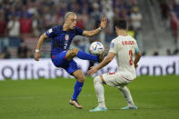 Sergino Dest of the United States, left, fights for the ball with Iran's Ehsan Hajsafi during the World Cup group B soccer match between Iran and the United States at the Al Thumama Stadium in Doha, Qatar, Tuesday, Nov. 29, 2022. (AP Photo/Ebrahim Noroozi)