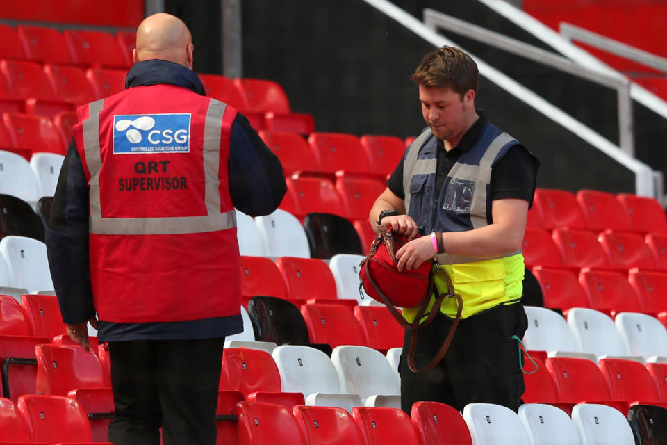 Police search a bag in the stands after fans were evacuated prior to the Barclays Premier League match between Manchester United and AFC Bournemouth at Old Trafford stadium on May 15, 2016, in Manchester, England. (Alex Livesey/Getty Images)