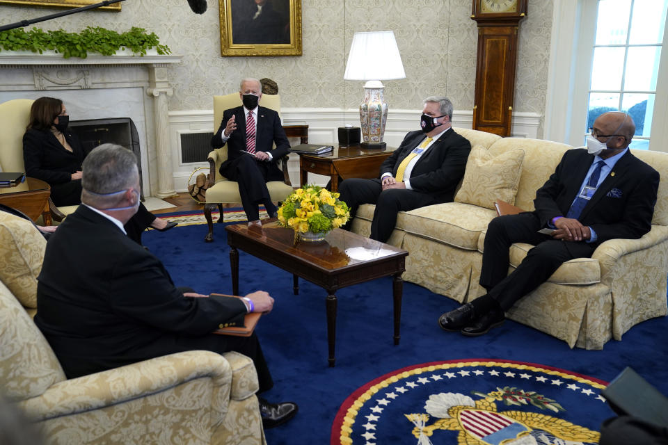 President Joe Biden and Vice President Kamala Harris meet with labor leaders in the Oval Office of the White House, Wednesday, Feb. 17, 2021, in Washington. Eric Dean, general president of the Ironworkers International Union, second from right, and Kenneth Rigmaiden, general president of the International Union of Painters and Allied Trades, right, listen. (AP Photo/Evan Vucci)