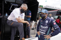 Fernando Alonso, of Spain, talks with Gil de Ferran following a practice session for the Indianapolis 500 auto race at Indianapolis Motor Speedway, Wednesday, Aug. 12, 2020, in Indianapolis. (AP Photo/Darron Cummings)