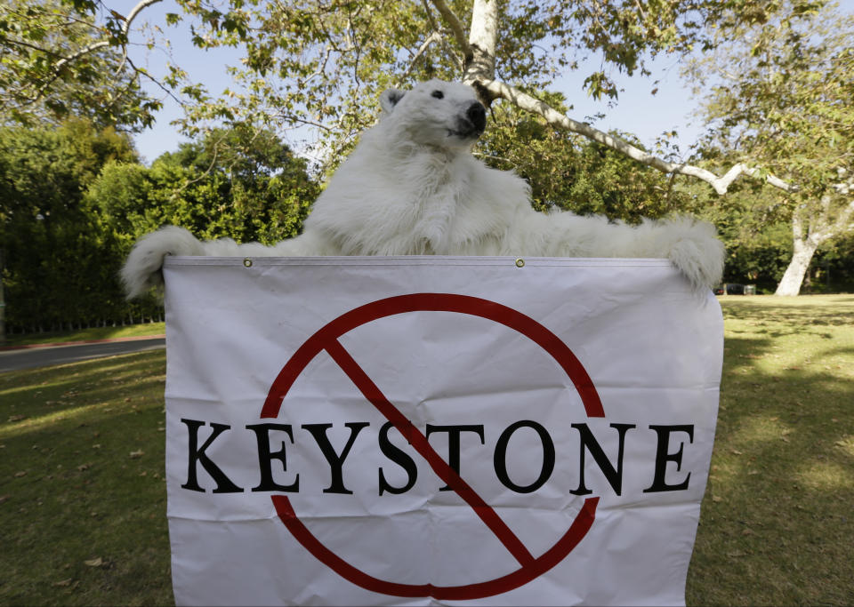 FILE - In this May 7, 2014, file photo, a member of the Center for Biological Diversity in polar bear costume protests the Keystone XL pipeline during a visit by then President Barack Obama for a two-day visit to Los Angeles. The sponsor of the Keystone XL crude oil pipeline says it's pulling the plug on the contentious project, Wednesday, June 9, 2021, after Canadian officials failed to persuade the Biden administration to reverse its cancellation of the company's permit. (AP Photo/Damian Dovarganes, File)