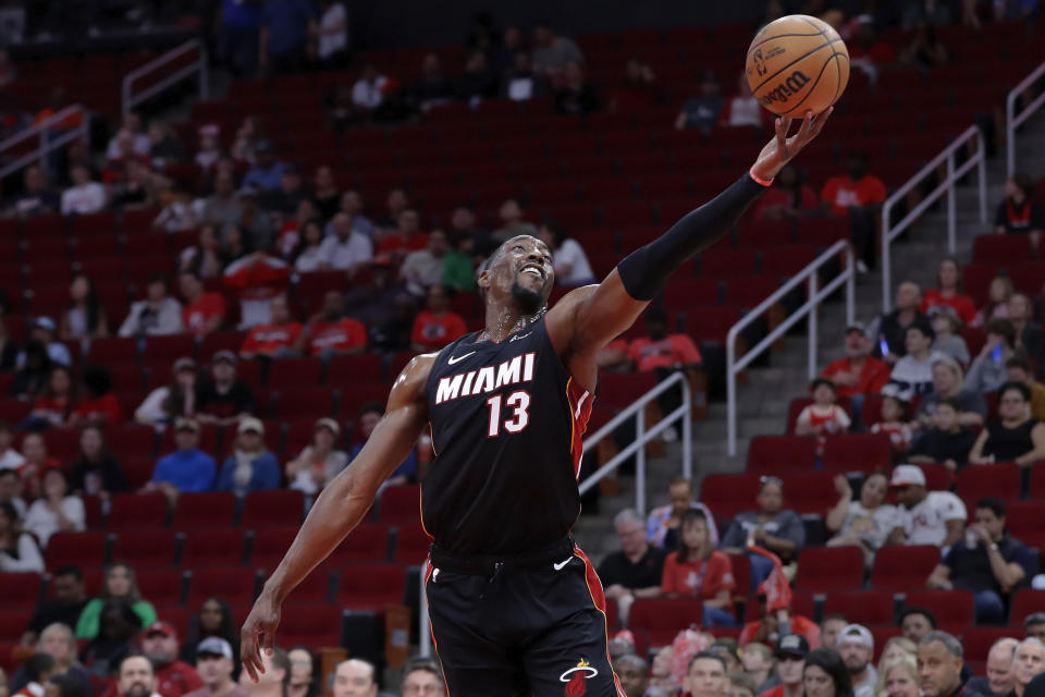 Miami Heat center Bam Adebayo reaches for a rebound against the Houston Rockets during the first half of an NBA basketball game Friday, Oct. 20, 2023, in Houston. (AP Photo/Michael Wyke)