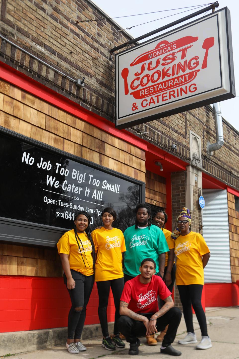 Monica Williams' team poses for a photo outside of the new location of Just Cookin' after moving from West End to Bond Hill.