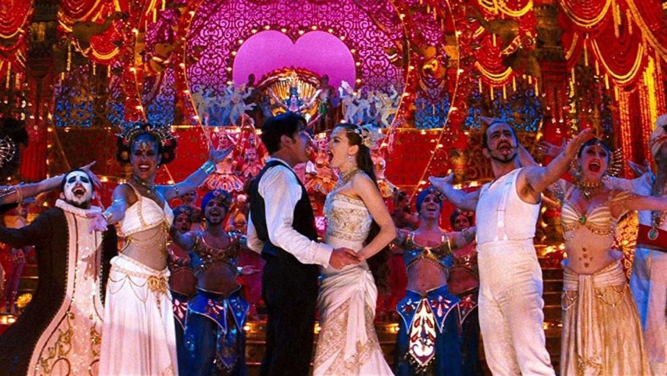 Ewan McGregor holds Nicole Kidman as they are surrounded by a decadent stage in a scene from the ending of Moulin Rouge!