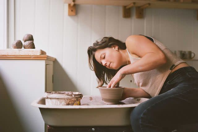 <p>Naomi Wood</p> Ceramicist Fi Underhill throwing a pot at Ground, her studio and shop in Frome.